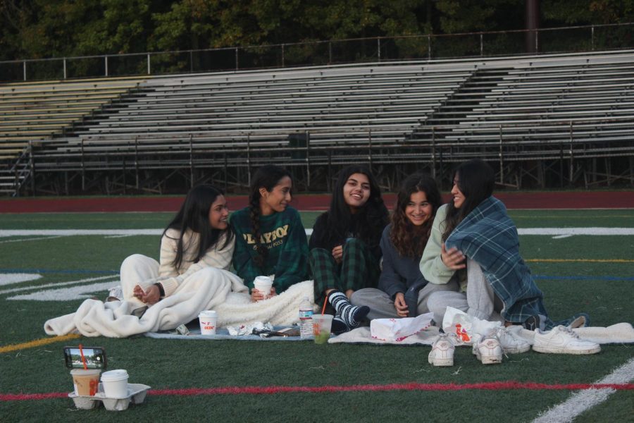 Seniors Neha Chandrakanth, Rhea Gupta, Khavya Harihara, Reva Bhalero, and Arushi Das laugh together while eating breakfast during the Senior Sunrise.