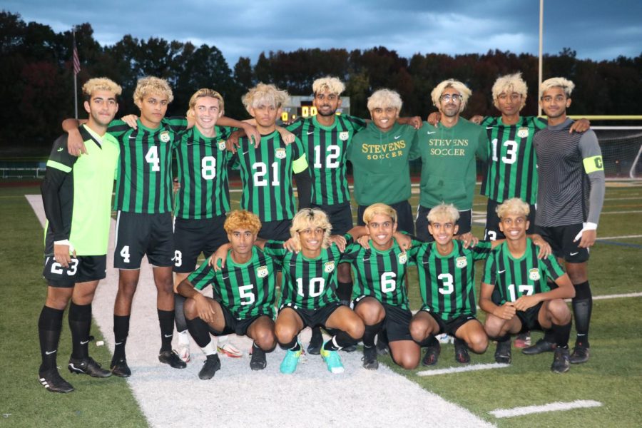 The boys varsity soccer players stand together after their Senior Night game.