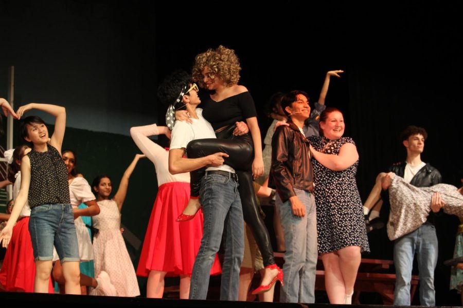 Nishanth Bhargava, who played Danny Zuko, and Reva Bhalerao, who played Sandy Dumbrowski, pose together at the end of their final musical performance.