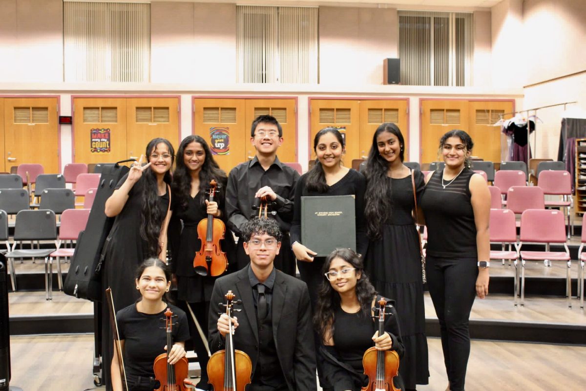 Members of the orchestra program together at the concert.