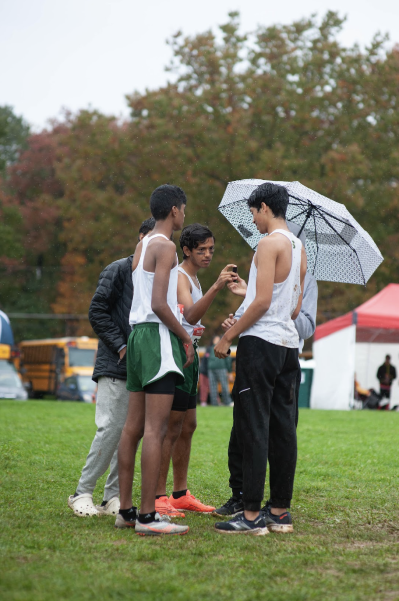 Cross country runners come together during a meet.