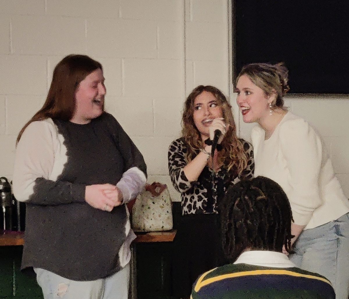 Senior Zariel Milshtein, senior Casey Decker, and Zara Diaz perform at Karaoke Night