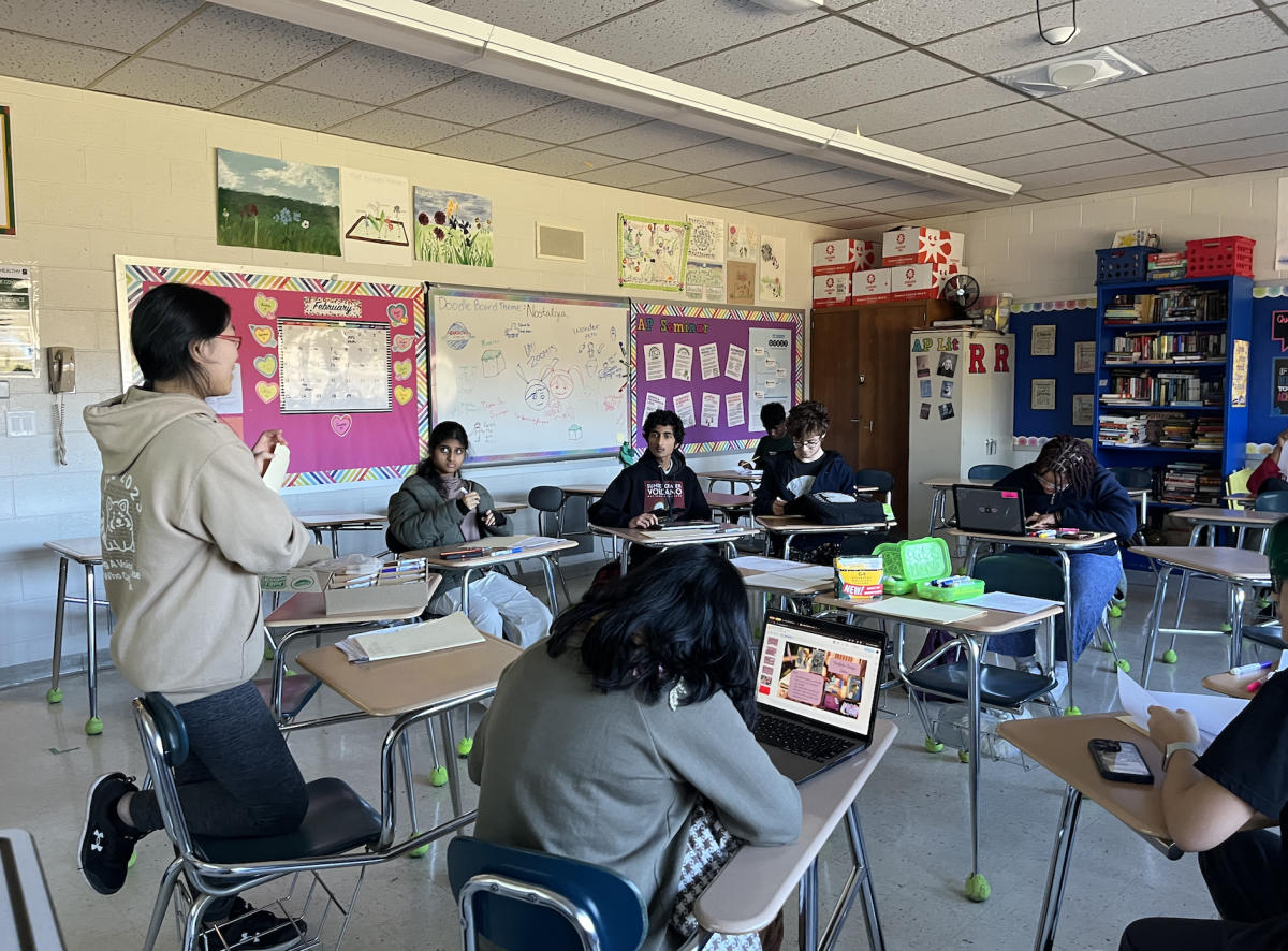 Students work on writing poetry at a Poetry Club 